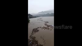 Heroic villagers use boat to save driver being washed away by flood