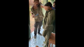 Indian herpetologist removes 2-foot snake from man's shirt