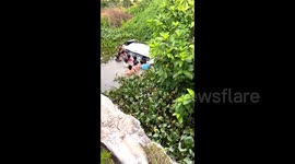 Heroic Chinese villagers rescue family from sinking car in river