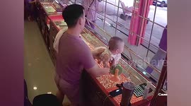 Dad with lighting fast reactions catches baby falling from shop counter