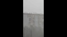Workers repair Moscow roof amid hurricane winds and heavy downpour