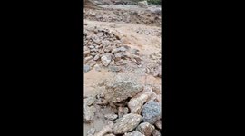 The terrible flash flood carried thousands of stones and flooded the village