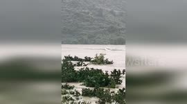 Hero villagers use boat to save driver being washed away by flood