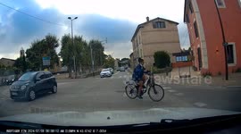 Dashcam ! A cyclist hidden by a car doesn't know the road code. Very dangerous.