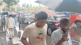 India: People Wade through rain in Kolkata