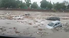 India: Rain in Haridwar, dry river flooded, many cars and buses swept away like toys
