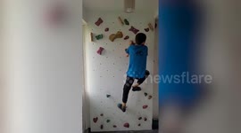 Dad transforms stairs into climbing wall so son can practice