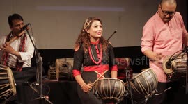 Nepal: A Nepali woman plays a traditional instrument at an event in Kathmandu