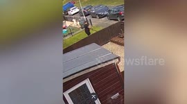 Moment gardener smashes through neighbour's fence while mowing lawn