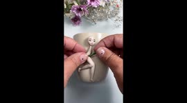 Artist's enchanting polymer clay 'Tinkerbell' decoration transforms plain mug into unique masterpiece
