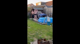 Man's poolside pogo stick jump ends in a big splash