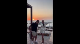 Wave of love: Man proposes to his girlfriend under the setting sun
