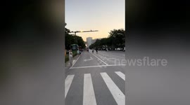 Locals play badminton in middle of busy street in China