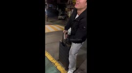 Man boards luggage and slides downhill