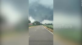 Dramatic footage shows huge tornado twisting across fields in Indiana