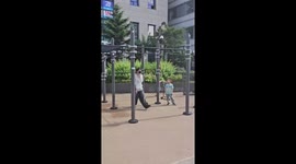 Schoolboy performs calisthenics on pull-up bar