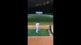 Talented toddler plays golf with huge one wood at driving range