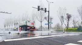 China: A Sprinkler Truck Working on The Road in Yancheng, China
