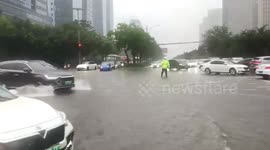 China: Zhengzhou Traffic Police Brave Torrential Rain to Safeguard Streets Amidst Flooding