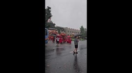 Wedding procession wades through flooded roads during rain in China