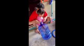 Toddler gets her arm stuck in giant water dispenser bottle