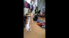 A black Angora cat was evacuated when it was trapped in a major flood in Indonesia