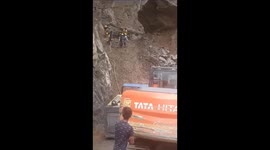Workers clearing debris on Badrinath Highway in Uttrakhand narrowly escape falling boulders