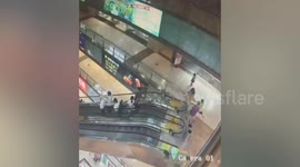 Boy falls from escalator while sitting on handrail in China