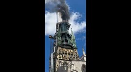 Close up footage of flames spewing from spire of France's Rouen cathedral