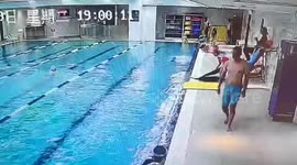 Heroic coach leaps into swimming pool to save drowning child in China