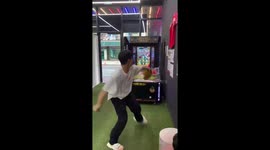 Man throws baseball hard breaking arcade machine