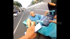 Traffic cops sprint to stop runaway three-wheeler, rescuing elderly rider after crash