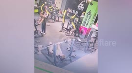 Gymgoer doing bench press falls when weights collapse