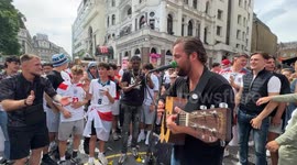 Street musician sings with England football fans ahead of the euros final against Spain