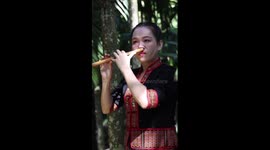 Chinese woman plays music on flute with nose