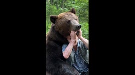 Tame bear poses for cute photoshoot with owner in Russia