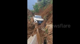 Motorists lucky to escape unharmed as landslide pushes car off cliff in China