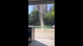 Dust devil appears in parking lot in China