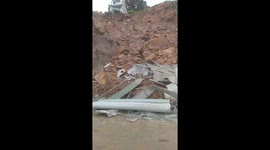 The landslide completely destroyed the two-story house and left neighboring houses severely damaged