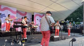 Big crowd dances cumbia in the live show of Los Mirlos from Peru at Malmö Sommarscen, Sweden.
