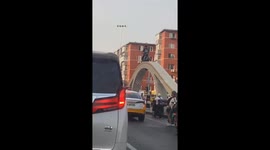 Daredevil scooter rider ingeniously escapes traffic jam by scaling arch in eastern China