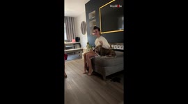 Elder sister dresses up the little boy with perfect style harmony