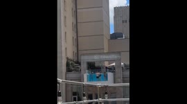 Guys at rooftop pool party unknowingly moon girls recording from adjacent building