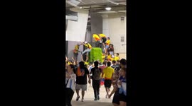 Soccer Fans Climb Over Fence at Stadium