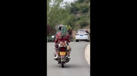 Woman carrying mop makes it look like her wacky hairstyle