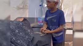 Palestine: Injured Palestinian Boy Stands by His Mother During Treatment After Israeli Airstrike
