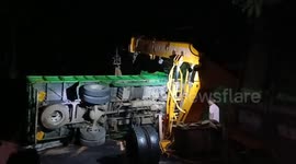 Rice-laden truck overturns in southern India, spilling 200 packets of rice; driver escapes unharmed