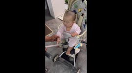 Baby insists on holding onto stroller handle