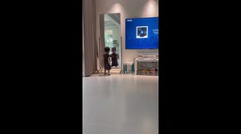 Sweet toddler poses in front of mirror showing dance moves