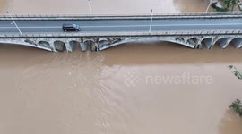China: Qingjiang River Floods Run Under Tunpu Bridge in Enshi